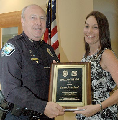 Palm Bay Police Department Chief Doug Muldoon presents to Crime Analyst Dawn Strickland the Civilian of the Year award for her consistent and effective efforts at helping detectives and patrol officers with research and information needed to help with criminal investigations.   